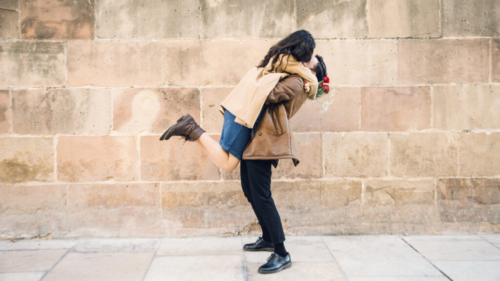 couple-hugging-near-brick-wall